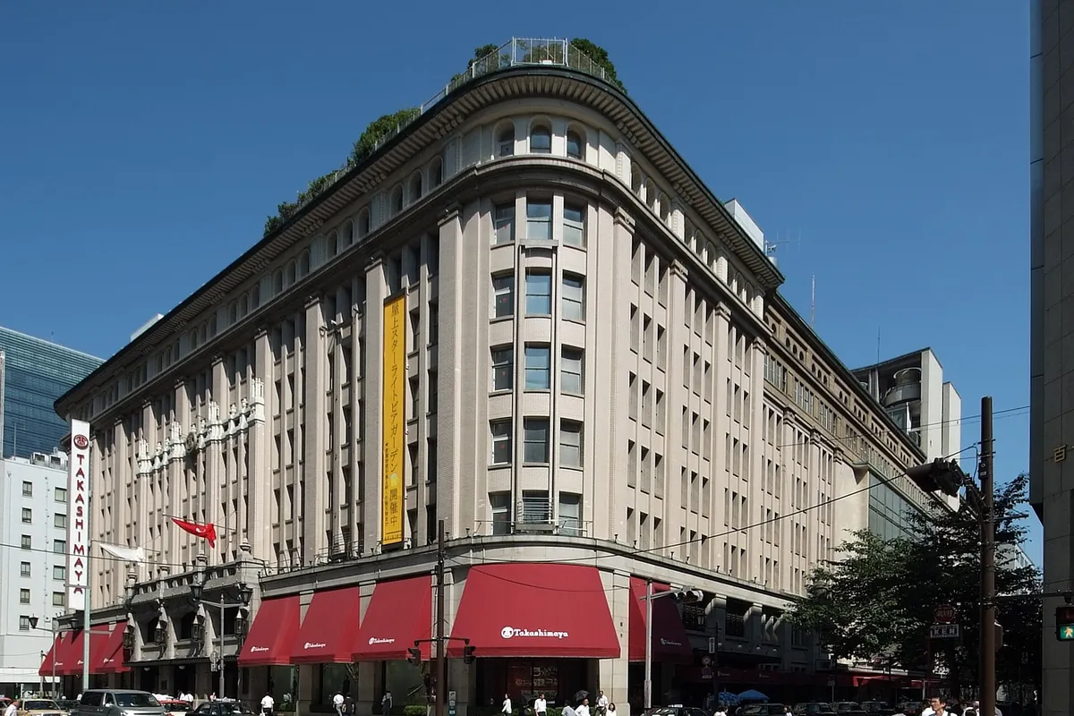 Exterior of the Takashimaya Nihonbashi department store building with red awnings in Tokyo