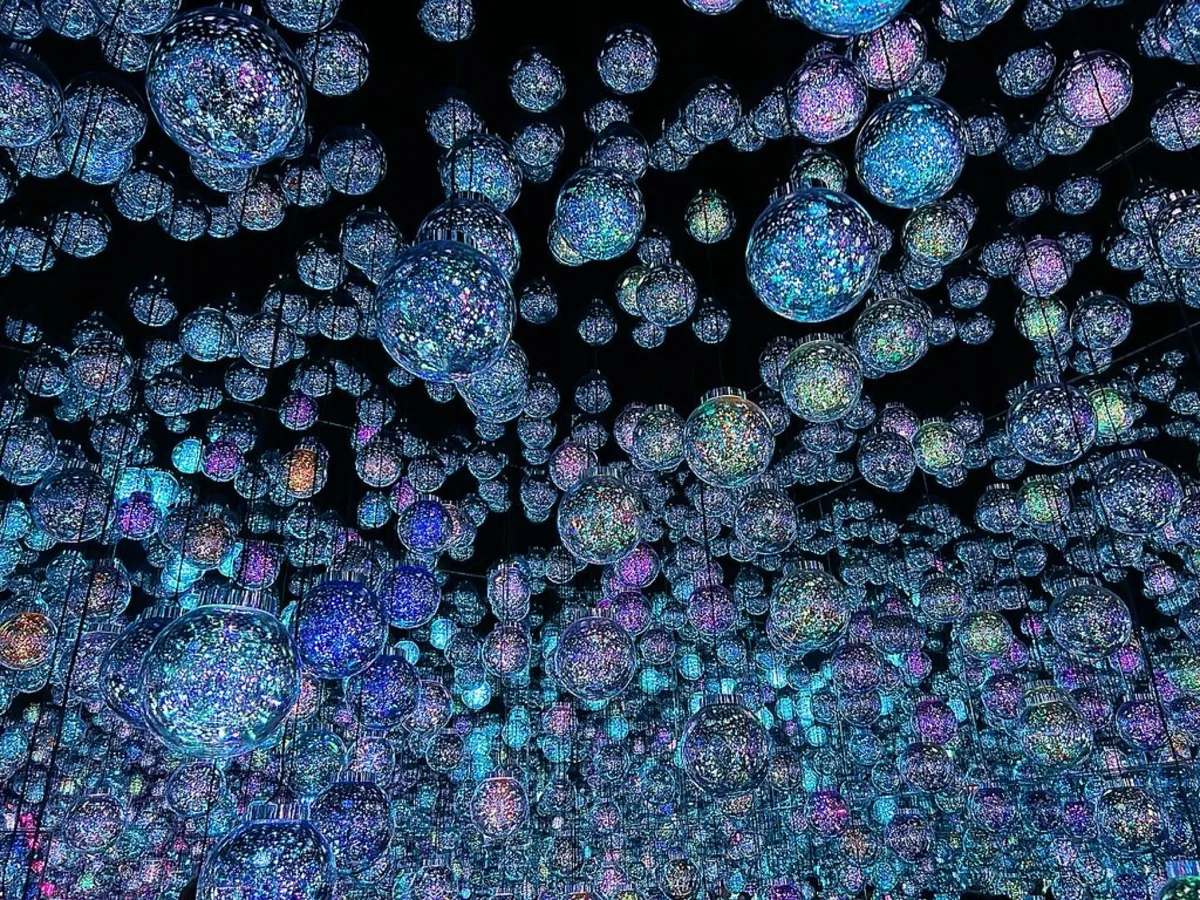 Hundreds of glowing bubble-like spheres hanging in the dark