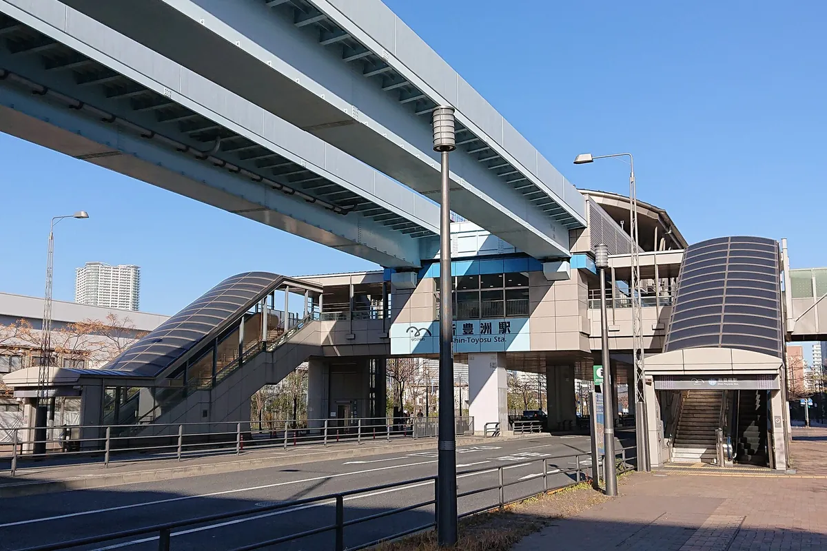 Shin-Toyosu Station building on the Yurikamome line, with an elevated track and escalators in Tokyo