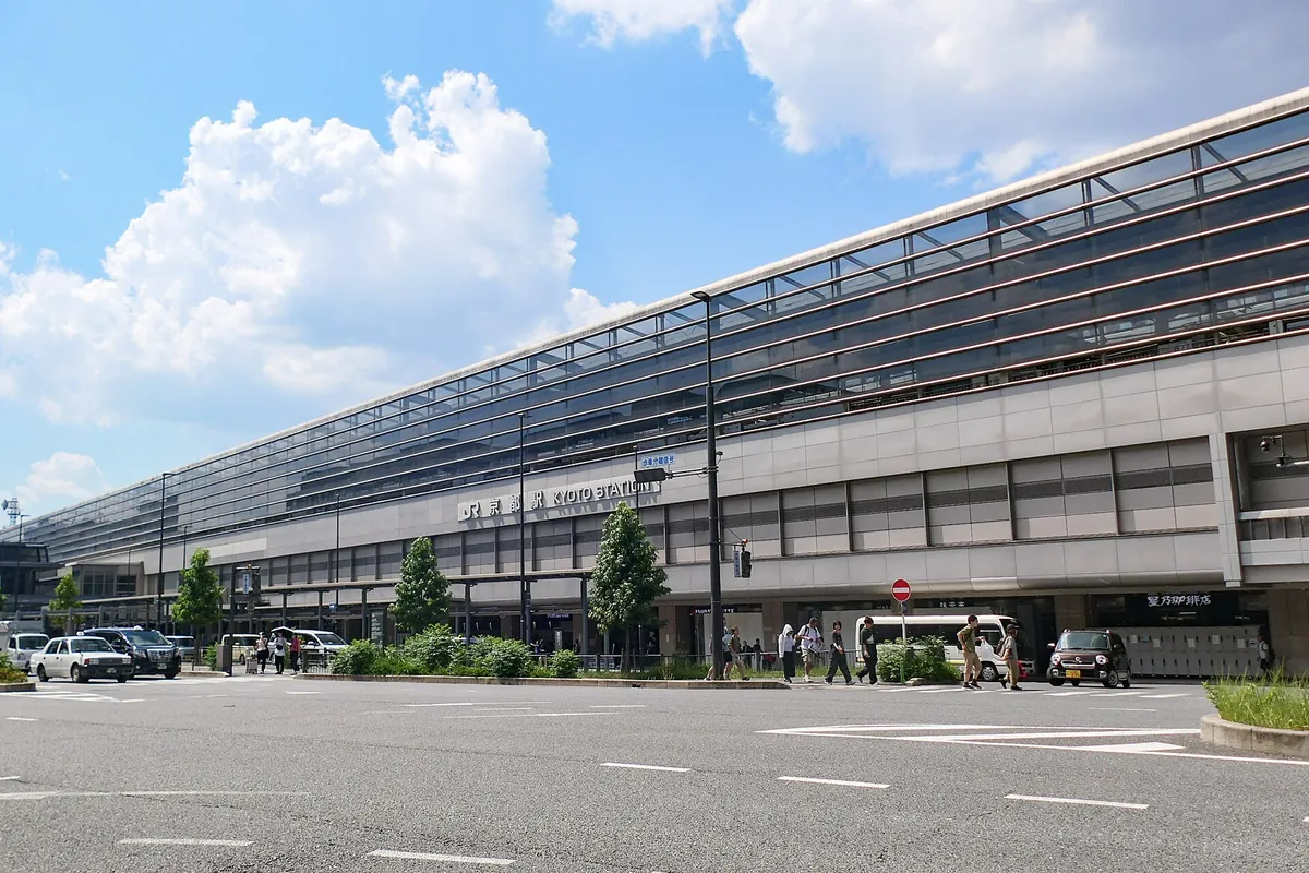Exterior of the Hachijo Exit building at Kyoto Station with taxis and pedestrians outside