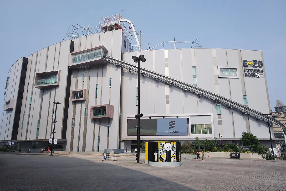 Exterior of the BOSS E・ZO FUKUOKA building with a rooftop roller coaster track