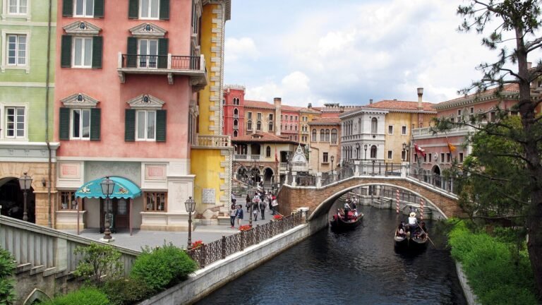 Mediterranean Harbor at Tokyo DisneySea with colorful Italian-style buildings, a stone bridge, and gondola boats on the water