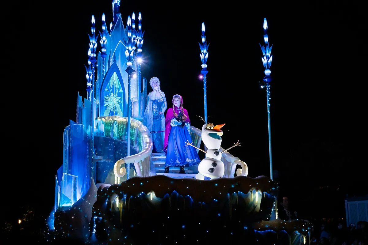Illuminated parade float at Tokyo Disneyland's Electrical Parade Dreamlights, with Elsa, Anna, and Olaf on an icy castle